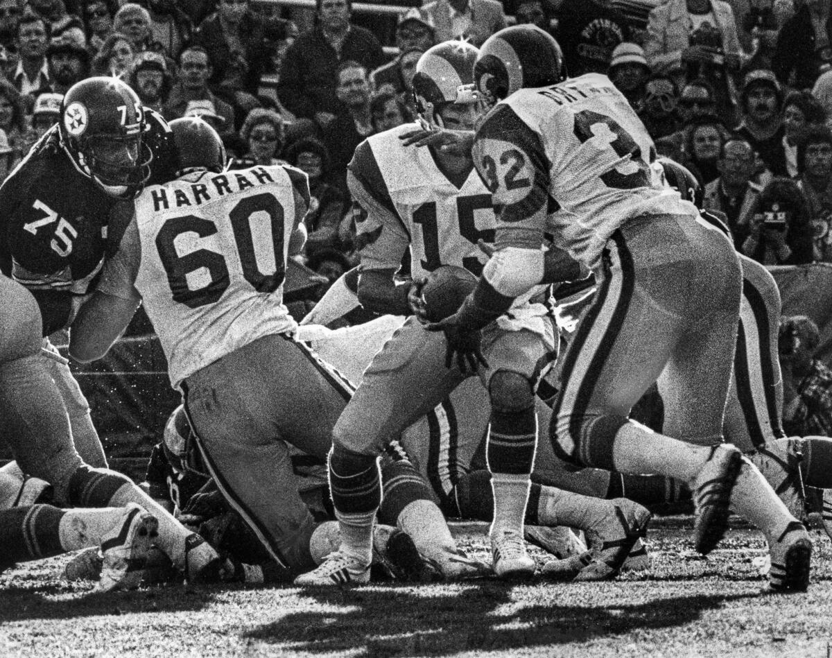 Jan. 20, 1980: Ram quarterback Vince Ferragamo (15) hands off to Cullen Bryant (32) as Dennis Harrah (60) blocks Pittsburgh's Joe Greene (75).