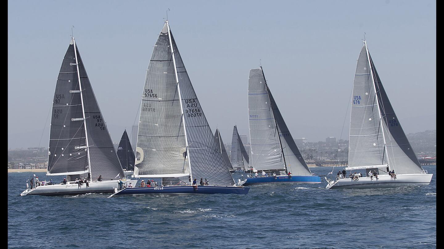 Racers in the PHRC class including Holua, Medicine Marn and Pyewacket, from right, get their start in 70th annual Newport to Ensenada International Yacht Race in Newport Beach on Friday. The race, which dates to 1948, started under sunny skies and light 8 knot breezes.