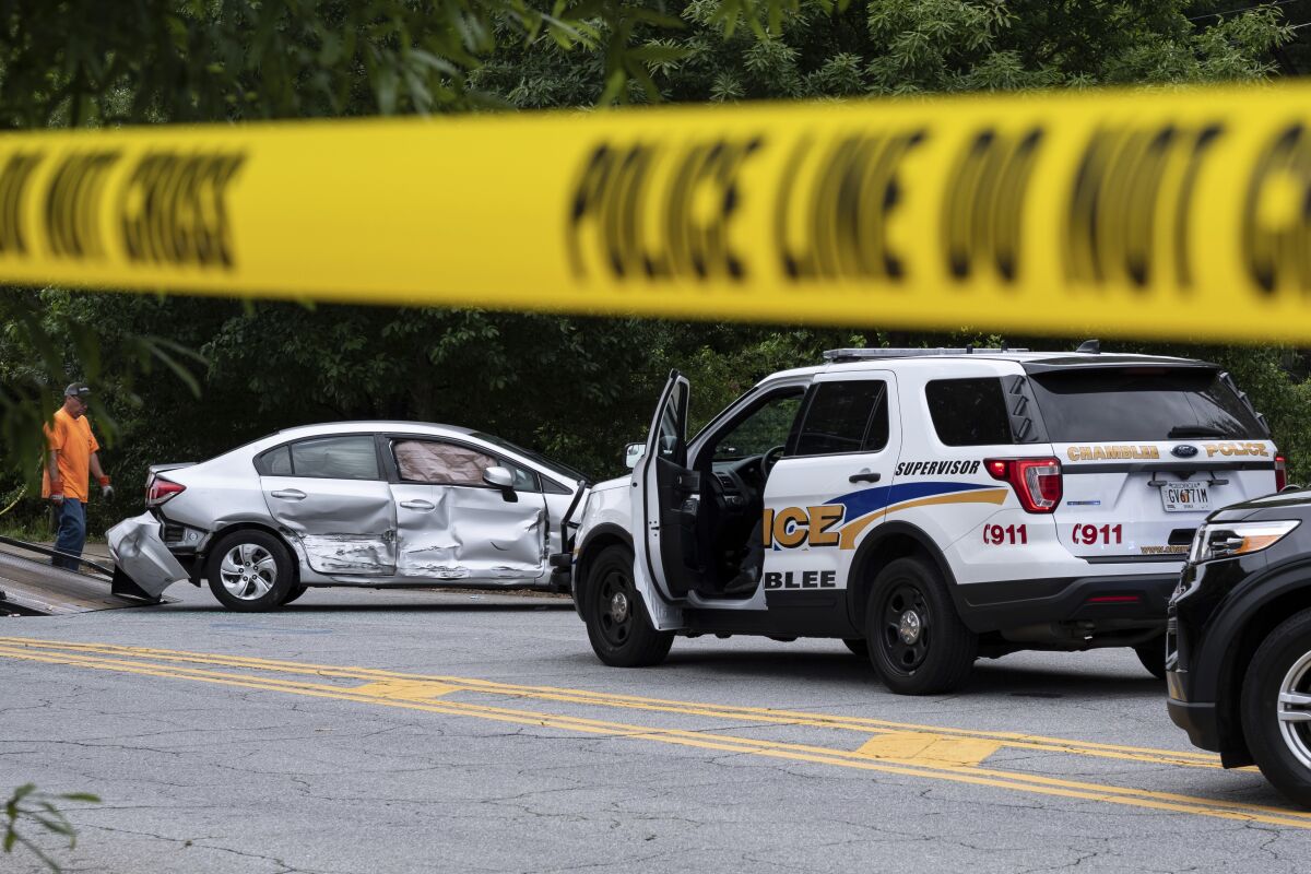 A wrecked car is removed from the scene where police fatally shot a man in downtown Decatur, Ga. on Tuesday morning, May 18, 2021. (AP Photo/Ben Gray)
