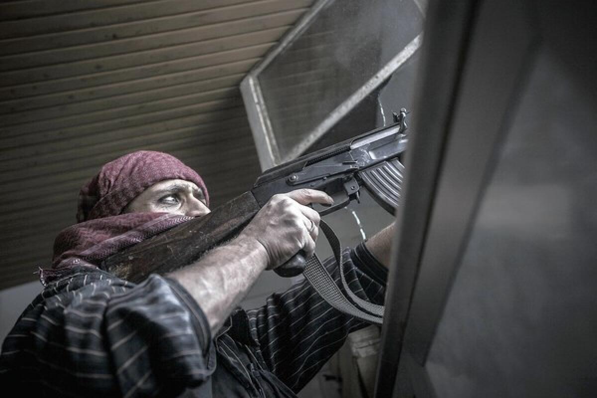 A Syrian rebel sniper fires at government troops in Aleppo. Each side warned the other Thursday against using a four-day cease-fire, set to begin Friday, as an opportunity to regroup.