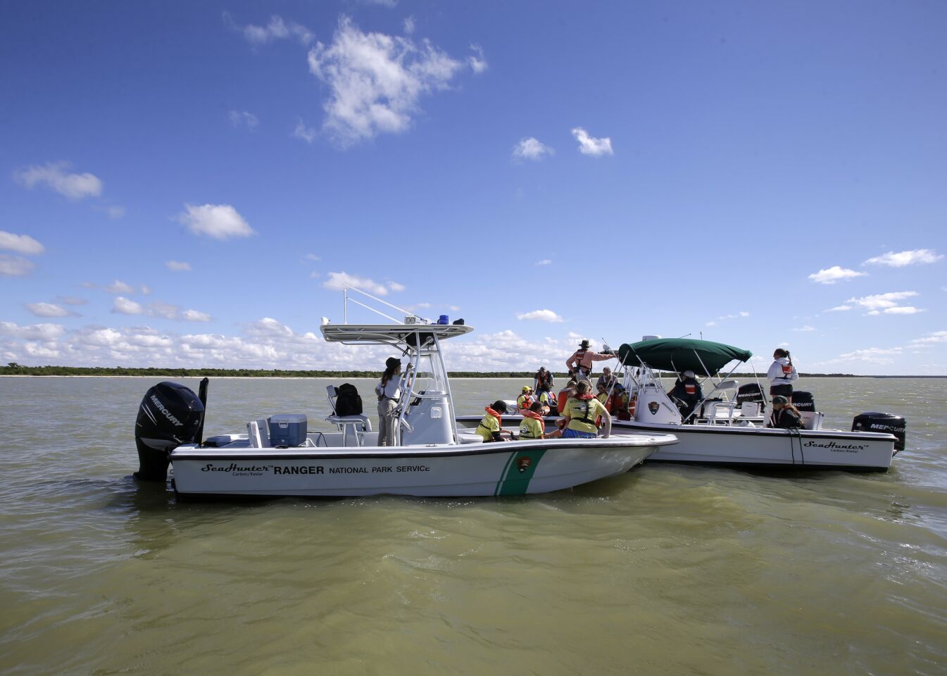 National Park Rangers and NOAA specialists search the ocean for stranded pilot whales,Thursday, Dec. 5, 2013, in the Everglades National Park, Fla.