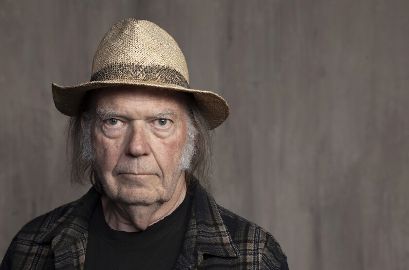 Neil Young poses for a portrait at Lost Planet Editorial in Santa Monica, Calif. on Sept. 9, 2019. Young had a barn rebuilt in the Rockies and used it to reunite with his old backing band Crazy Horse. The little log structure from the 1850s lends its name to the album that resulted, just called “Barn.” It will be released Friday along with a documentary of the same name directed by Young's wife Daryl Hannah. (Photo by Rebecca Cabage/Invision/AP, File)
