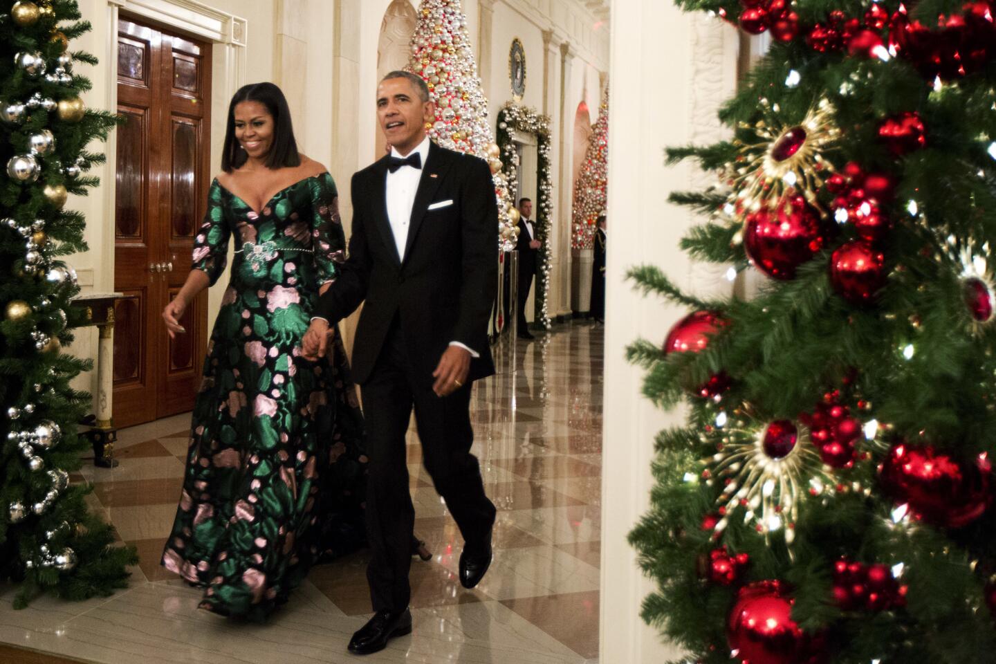 President Barack Obama and First Lady Michelle Obama arrive for a reception to honor recipients of the 2016 Kennedy Center Honors in the East Room of the White House in Washington, D.C.