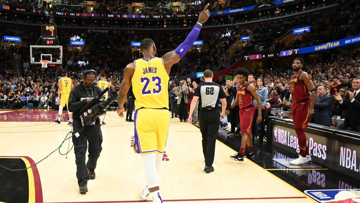 LeBron James recognizes the fans after the Cleveland Cavaliers honored James during a timeout at Quicken Loans Arena.