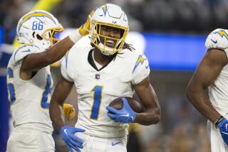 Los Angeles Chargers wide receiver Quentin Johnston (1) smiles after scoring a touchdown during the first half.