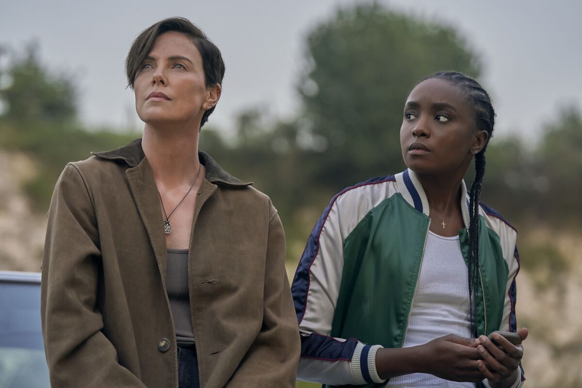 Charlize Theron, left, and KiKi Layne in the movie "The Old Guard."