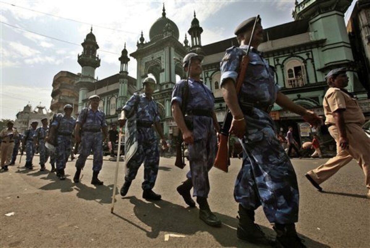 India's Rapid Action Force soldiers patrol in front of a mosque in Mumbai, India, Thursday, Sept. 30, 2010. An Indian court ruled Thursday that a disputed holy site in Ayodhya that has sparked bloody communal riots across the country in the past should be divided between the Hindu and Muslim communities, a lawyer involved in the suit said. The Muslim community said it would appeal the ruling in the 60-year-old case to the Supreme Court. Muslims revere the compound in Ayodhya as the site of the now-demolished 16th century Babri Mosque, while Hindus say it is the birthplace of the god Rama. (AP Photo/Rajanish Kakade)