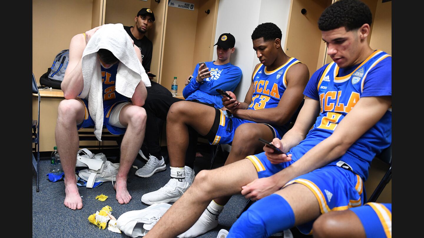 UCLA's TJ Leaf, Ike Anigbogu and Lonzo Ball (left to right) sit in the locker room after being eliminated by Kentucky in Sweet 16 round of the NCAA tournament on March 24.
