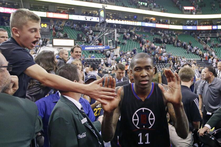 A fan high-fives Clippers guard Jamal Crawford (11) after a game against the Utah Jazz on Apr. 8.