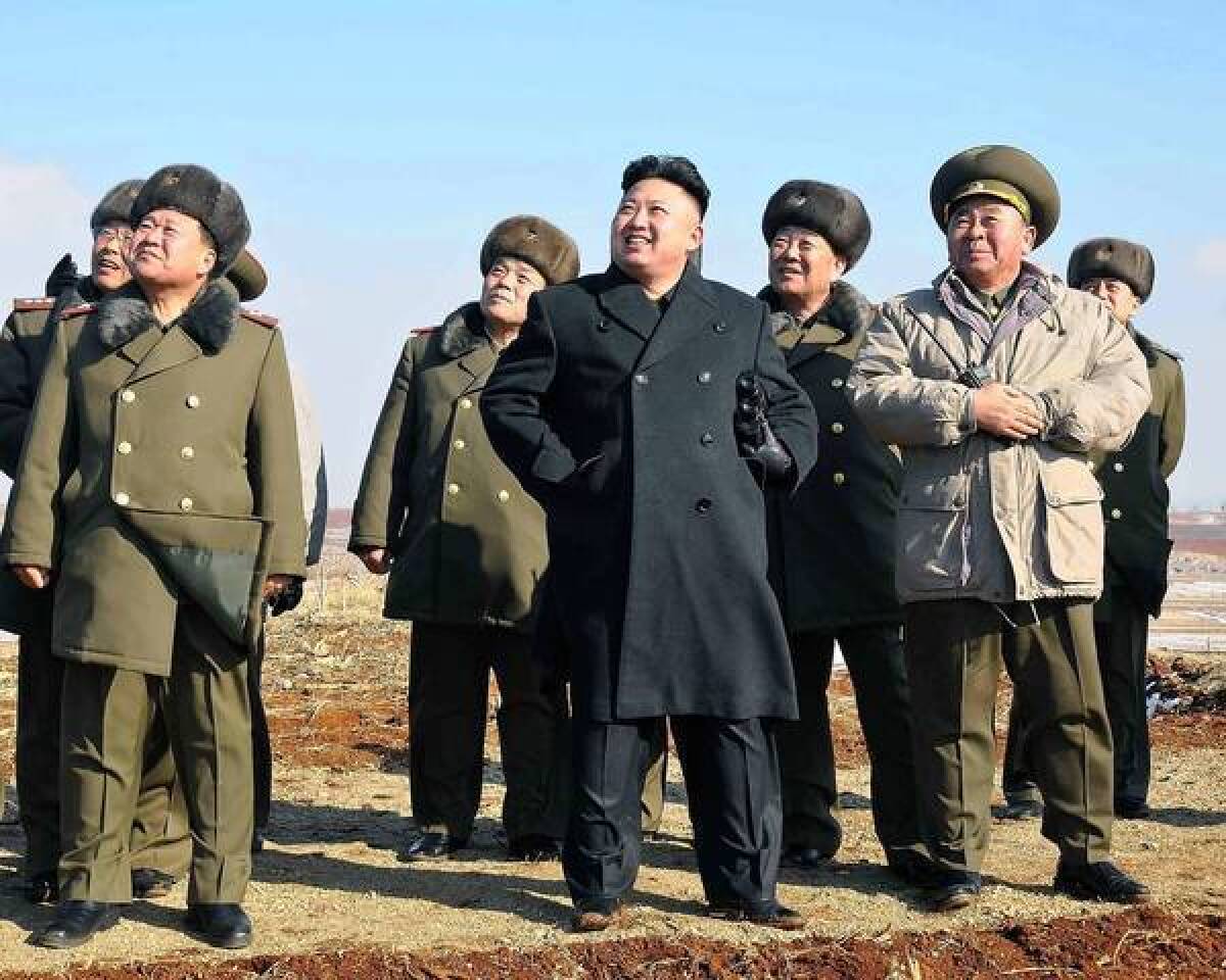 North Korean leader Kim Jong Un, center, appears to enjoy watching a flight exercise in an undated photo released by North Korea's official Korean Central News Agency.