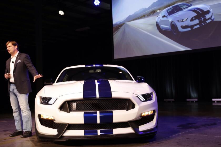 Jim Farley, Ford's executive vice president of global marketing, sales and service, shows off the new Shelby GT350 Mustang. It debuted Monday at the future Shelby museum in Gardena and will be on display at the L.A. Auto Show.