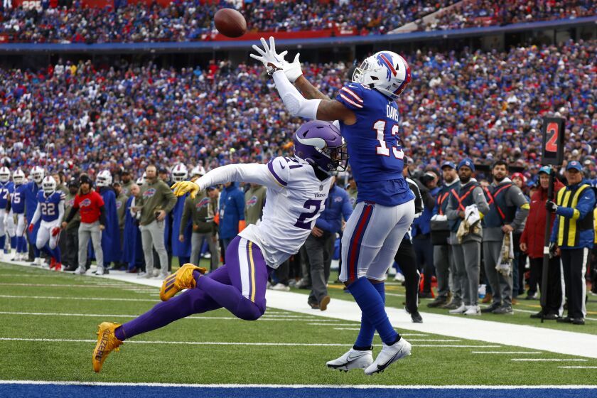 Buffalo Bills wide receiver Gabe Davis (13) catches a touchdown pass as Minnesota Vikings cornerback Akayleb Evans (21) tries to defend in the first half of an NFL football game, Sunday, Nov. 13, 2022, in Orchard Park, N.Y. (AP Photo/Jeffrey T. Barnes)