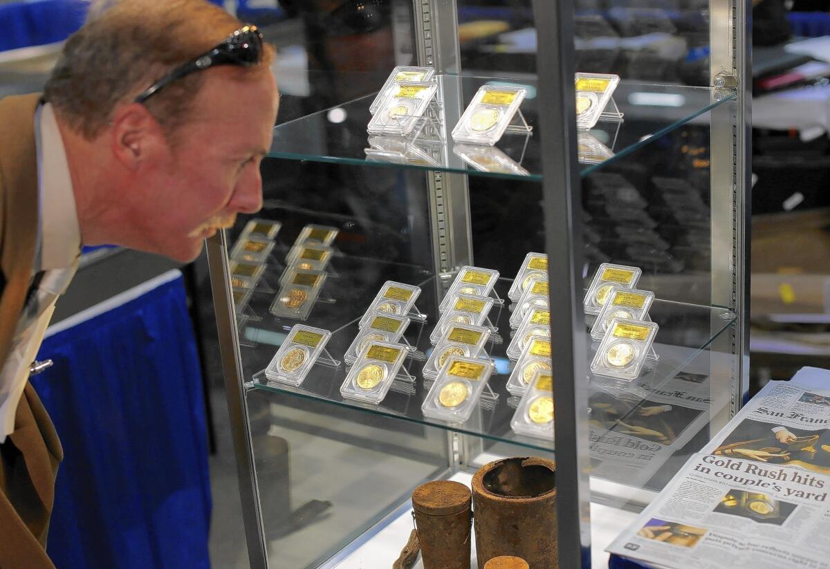 Some of the gold coins found by landowners in Saddle Ridge, Calif., are displayed at the National Money Show in Marietta, Ga., on Feb. 27.