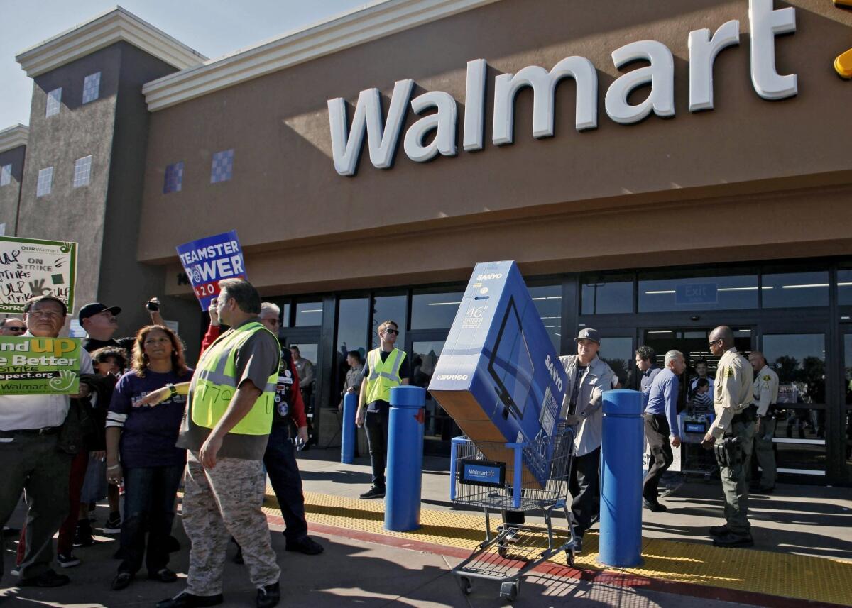 The National Labor Relations Board said earlier this month that union organizers can pay Black Friday protesters with a $50 gift card. Above, protesters at a Paramount, Calif., Walmart on last year's Black Friday.