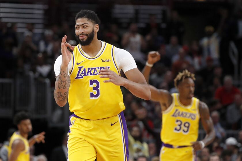 Los Angeles Lakers' Anthony Davis (3) celebrates a three-point basket during the second half of an NBA basketball game against the Chicago Bulls Tuesday, Nov. 5, 2019, in Chicago. The Lakers won 118-112. (AP Photo/Charles Rex Arbogast)
