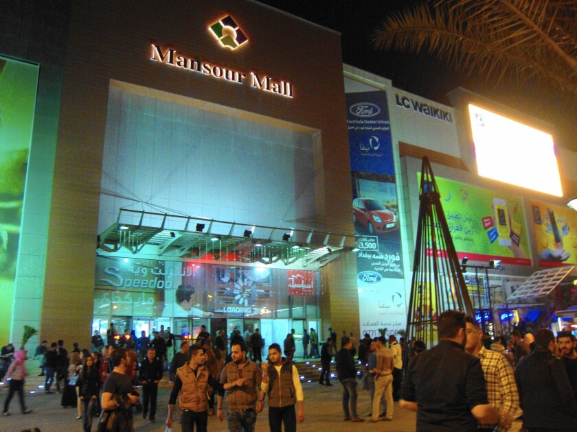 At Baghdad's Mansour Mall, visitors must go through metal detectors, file past armed guards and get a pat-down.