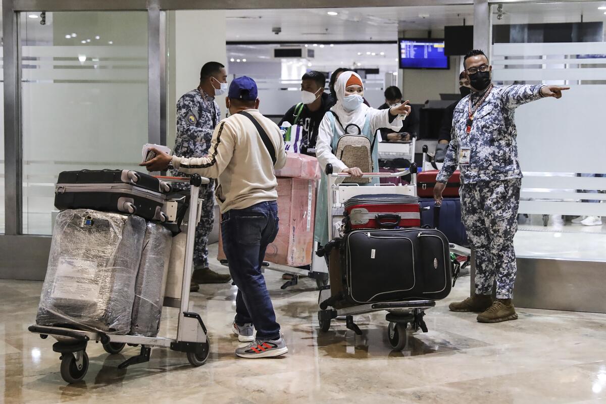 Airport passengers with luggage carts