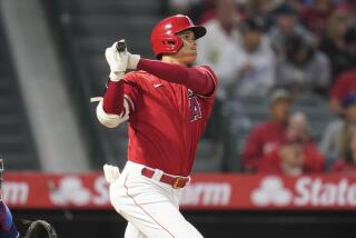 Los Angeles Angels' Shohei Ohtani (17) watches as his ball flies over the fence for a home run.