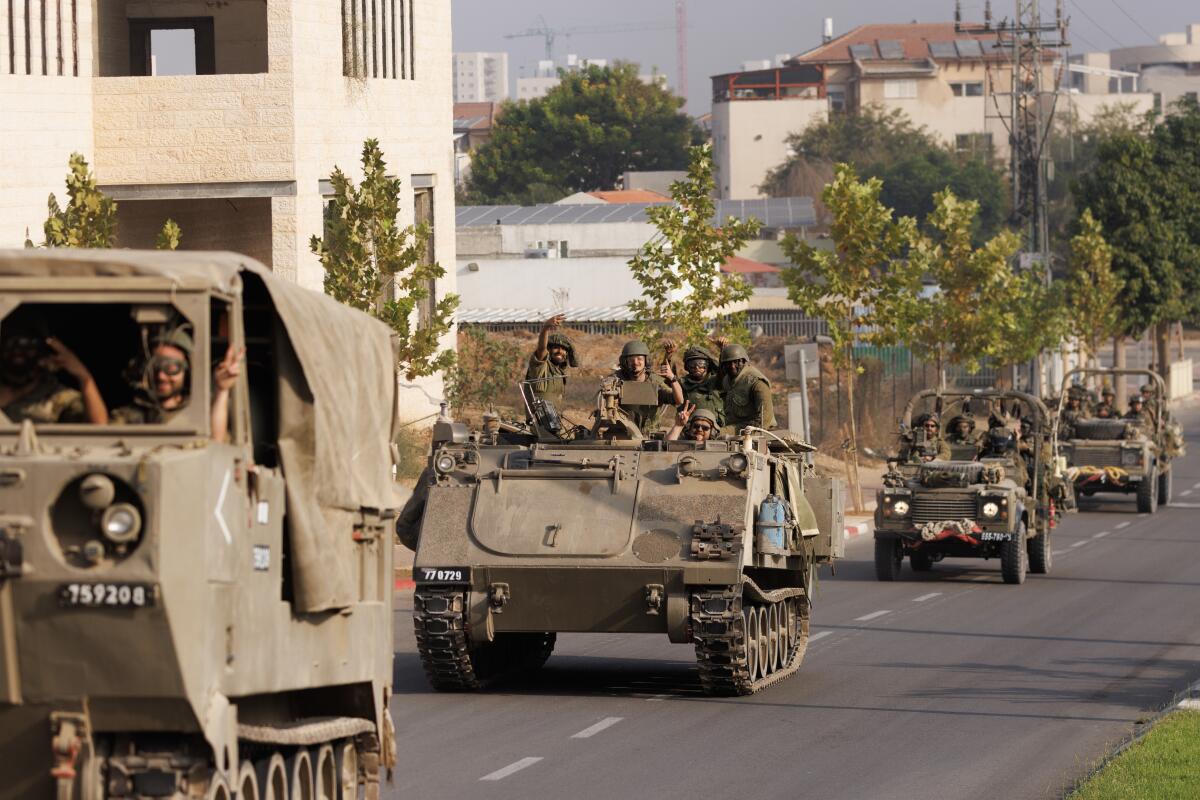 Israeli tanks and troops move near the border with Gaza.