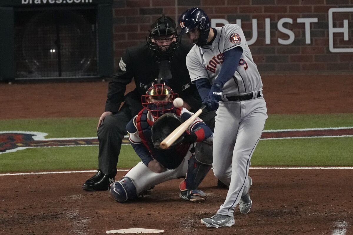 Houston Astros' Marwin Gonzalez hits a 2-RBI double during the fifth inning in Game 5 of baseball's World Series between the Houston Astros and the Atlanta Braves Sunday, Oct. 31, 2021, in Atlanta. (AP Photo/John Bazemore)