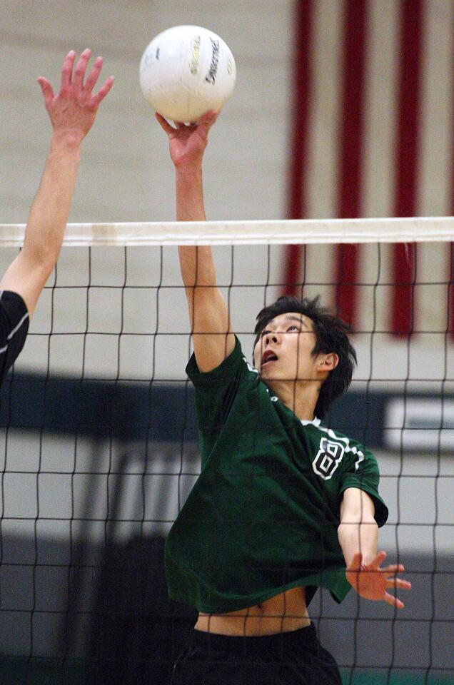Providence's Taylor Saldana hits the ball over against Oakwood in a boys volleyball match at Providence High School in Burbank on Monday, April 29, 2014.