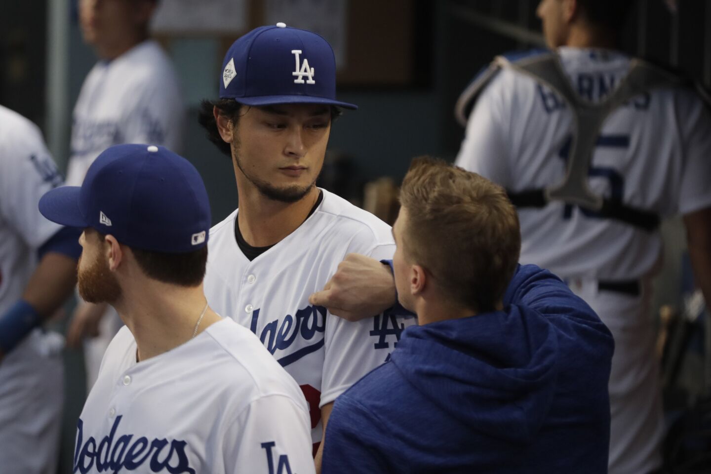 Enrique Hernandez encourages Yu Darvish in the dugout before the first pitch in Game 7 of the World Series at Dodger Stadium.