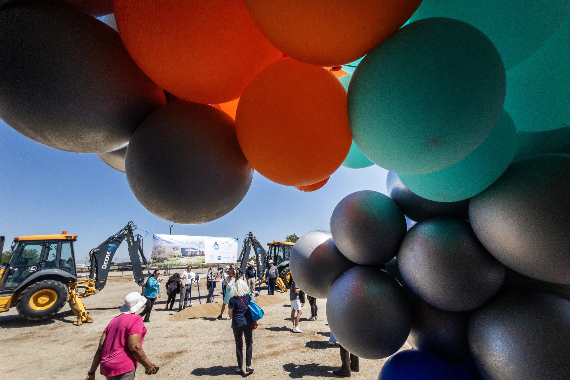 A photo of a cluster of balloons at a ground-breaking event.