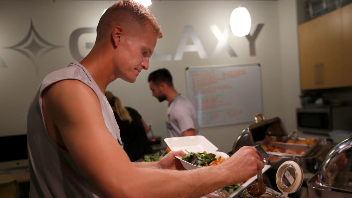 Galaxy goalie Jon Kempin eats lunch before a recent match.