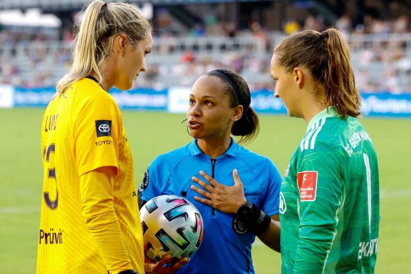 Referee Natalie Simon speaks with Katie Lund #23 of Racing Louisville FC and Laura Benkarth #1 of FC Bayern Munich