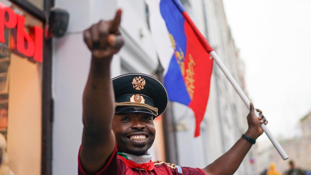 A souvenir vendor entices fans into his store near Red Square in Moscow.