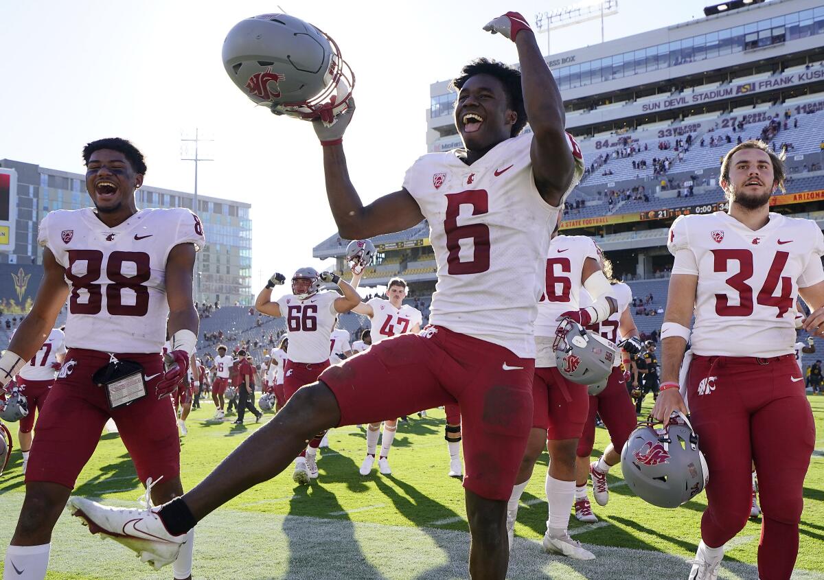 Washington State defensive back Chau Smith-Wade (6) and teammates rejoice in a win over Arizona State on Oct. 30, 2021.