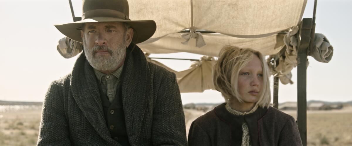 Tom Hanks and Helena Zengel in a wagon in old-western clothing in "News of the World."