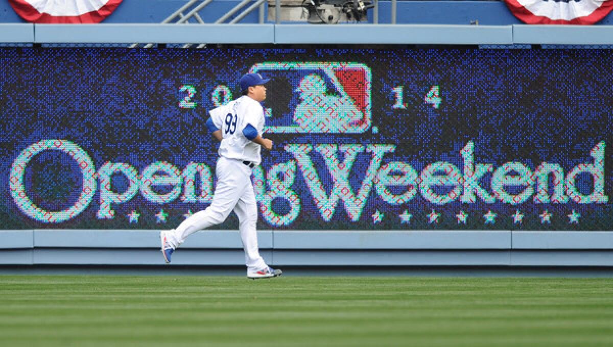 Dodgers starting pitcher Hyun-Jin Ryu warms up before the start of Friday's home opener against the San Francisco Giants. Mark Walter, Dodgers chairman and controlling owner, says he sympathizes with fans who are unable to watch the Dodgers.