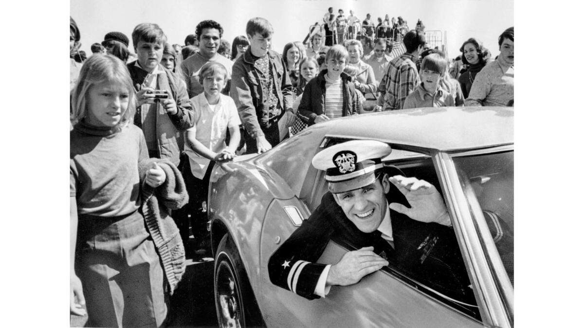 March 3, 1973: Navy Lt. George Rehmann, former Vietnam prisoner of war, waves from a car presented to him by residents of Antelope Valley during welcome-home ceremonies.
