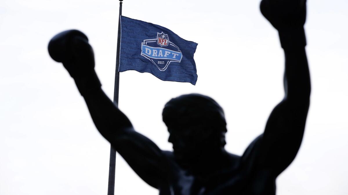 An NFL draft flag flies near the Rocky statue in Philadelphia.