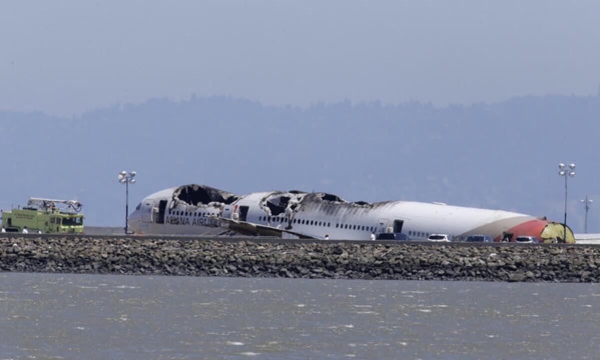 The wreckage of Asiana Flight 214 is seen on a tarmac at San Francisco International Airport in San Francisco on Wednesday.