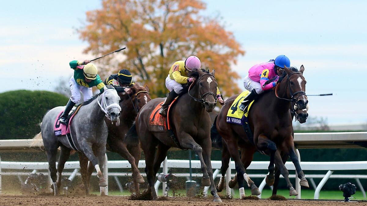 Jockey Joel Rosario guides Wavell Avenue (7) past La Verdad (4), with Jose Ortiz aboard, for victory in the Filly & Mare Sprint.