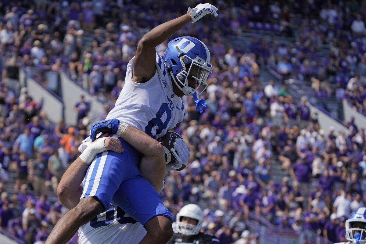 Duke's Jordan Moore (8) celebrates his touchdown against Northwestern during the second half of an NCAA college football game, Saturday, Sept.10, 2022, in Evanston, Ill. (AP Photo/David Banks)