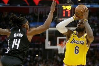 LOS ANGELES, CALIF. - NOV. 9, 2022. Lakers forward LeBron James puts up a shot against Clippers guard Terance Mann.