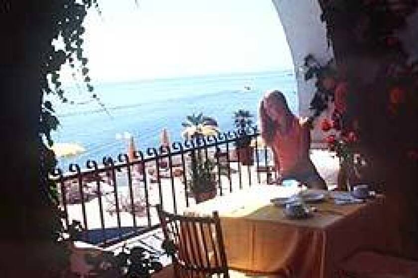 Enjoy your morning coffee  and the view  from an ocean-facing balcony at Liparis Hotel Carasco.