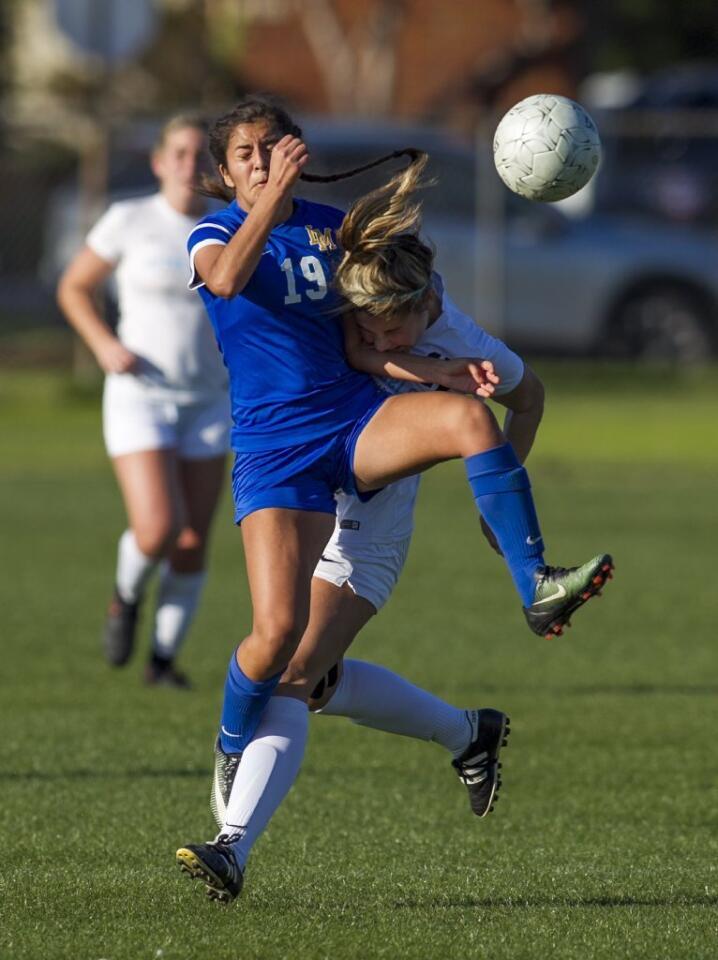 Corona del Mar's Katharine Caston collides with La Mirada's Lauren Garcia during the quarterfinals of the CIF Southern Section Division 2 playoffs on Friday.