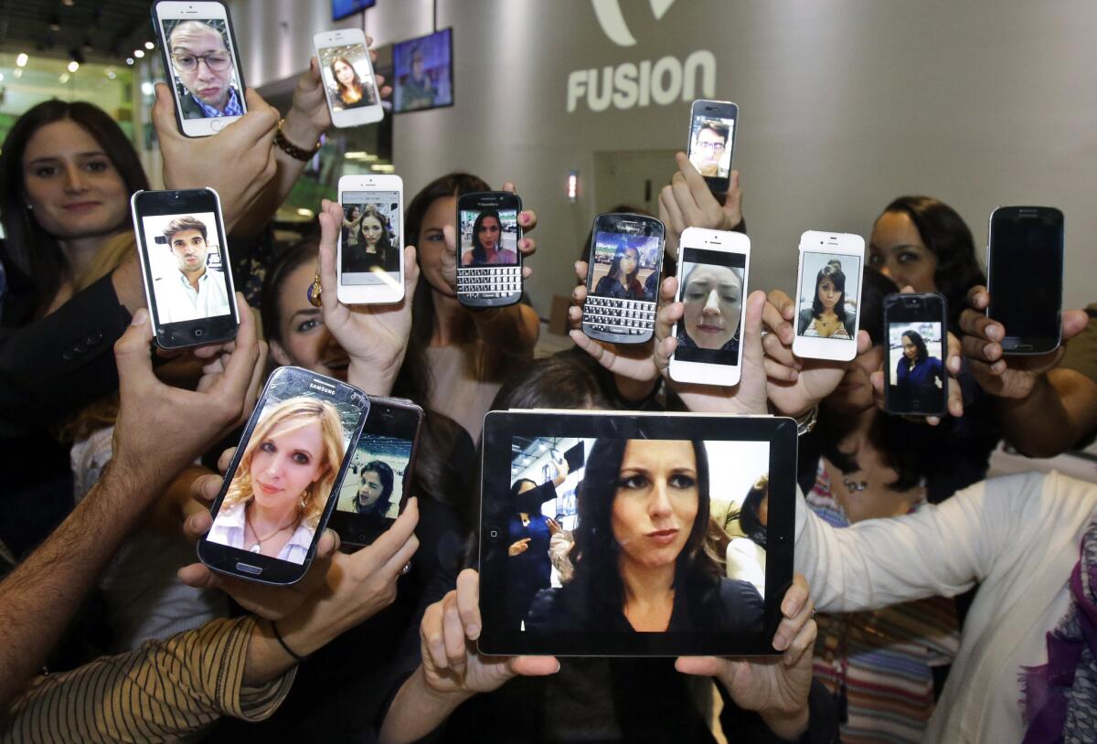 Alicia Menendez, host of the Fusion network's "Alicia Menendez Tonight," holds up a "selfie" with her production team.
