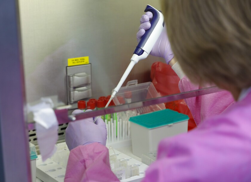 Kim Maceyko, a Sharp Healthcare clinical laboratory scientist, works with COVID-19 samples 