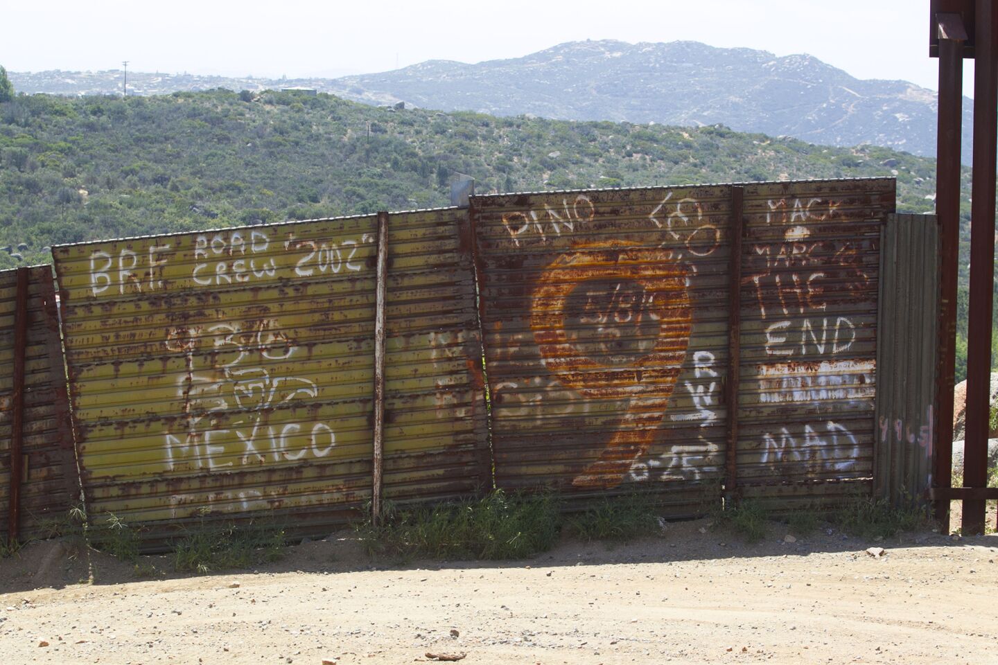 Here, an older part of the border fence shows graffiti.