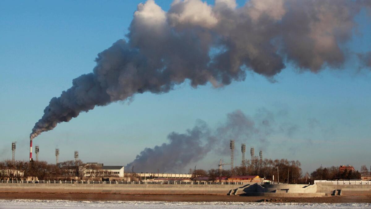A heating factory spews smoke in northeastern China's Heilongjiang province. Carbon emissions from burning fossil fuels have decreased, but scientists say it’s not enough to stave off dangerous global warming.