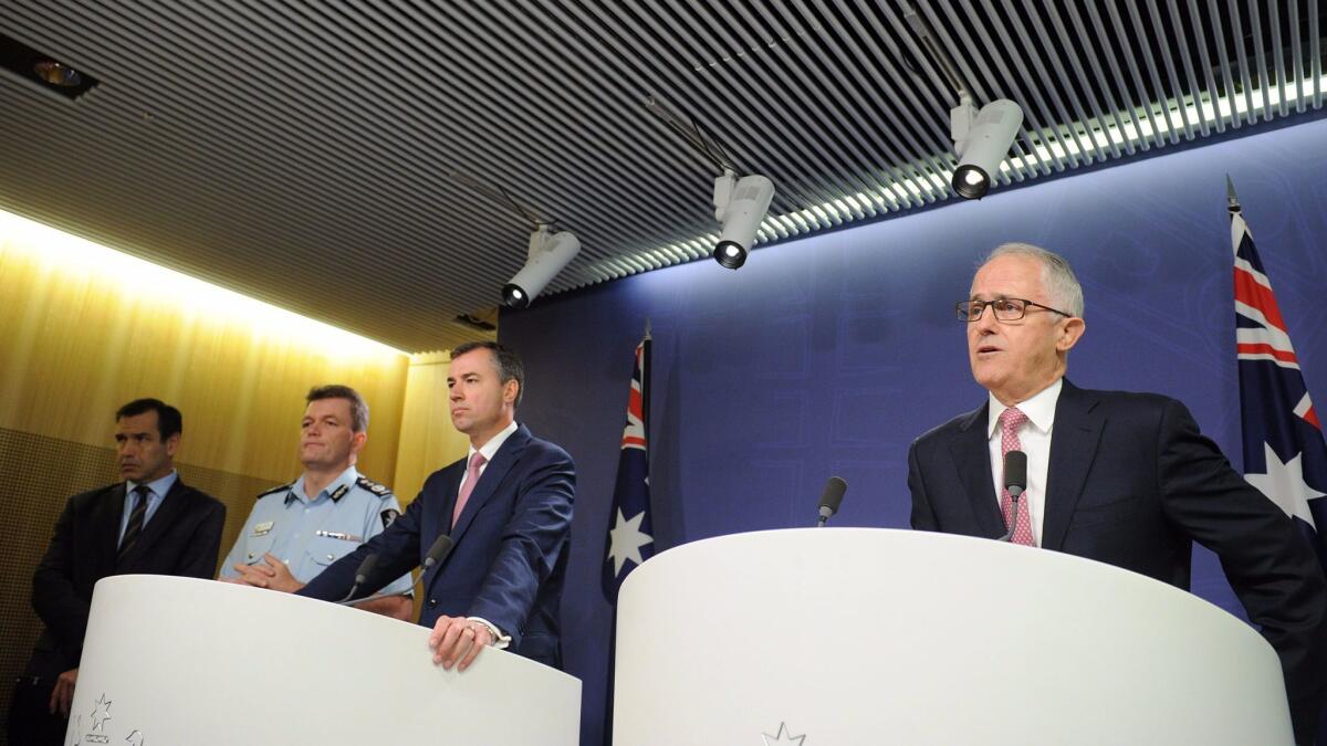 Australian Prime Minister Malcolm Turnbull, right, joined by Minister for Justice Michael Keenan and Australian Federal Police Commissioner Andrew Colvin, speaks to the media in Sydney, Australia, on Dec. 23, 2016.