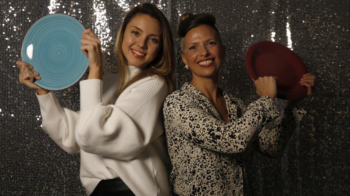 Women Breaking Plates organizers Danielle Kort, left, and Aria Tru in front of their sequined backdrop.