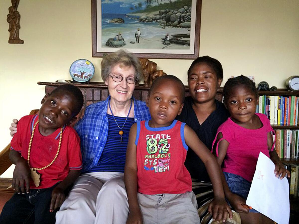 Sister Janice McLaughlin smiles with children.