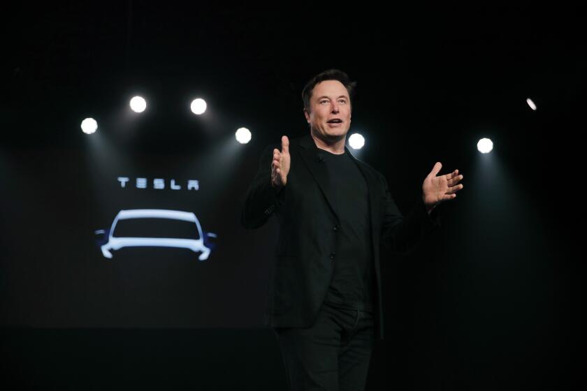 FILE- In this March 14, 2019, file photo Tesla CEO Elon Musk speaks before unveiling the Model Y at Tesla's design studio in Hawthorne, Calif. Tesla CEO Elon Musk says the electric car pioneer plans to build a new factory near Berlin. News agency dpa reported that Musk made the announcement during a prizegiving ceremony in the German capital Tuesday evening. (AP Photo/Jae C. Hong, File)
