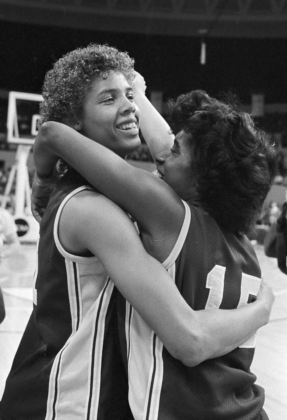 USC's Cheryl Miller, left, gets a hug from teammate Juliette Robinson after they defeated Georgia to move to the final game of the NCAA women's basketball tournament, in Norfolk, Va., on April 1, 1983.